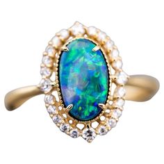 Engagement Ring: Australian Black Opal and Diamond in 18K Yellow Gold Free Domestic USPS First Class Shipping! Free Gift Bag or Box with every order! Opal—the queen of gemstones, is one of the most beautiful gemstones in the world. Every piece of opal is unique in its own ways and patterns. We only use high-quality Natural Opals (NO synthetics or imitations) for our jewelry. ---------------------------------------------------------------------------------------------------- ABOUT THIS PRODUCT Solid 18K Yellow Gold Australian Black Opal, 1.32 ct 24 Diamonds: 0.222 ct Opal Body Tone: N4 Opal Brightness: B4-B3 Opal Size: 10 x 6 mm Ring Size: 7 Opal Color: Stnning green and yellow hues. Occasion: Engagement/Anniversary --------------------------------------------------------------------------- Radiant Ring, Australian Black Opal, Beautiful Gemstones, Opal Color, Toned Body, Engagement Anniversary, Natural Opal, Black Opal, Opal Jewelry