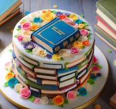 there is a cake made to look like books on top of each other and decorated with flowers