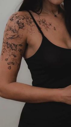 a woman with tattoos on her arm and shoulder