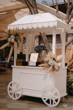 a white cart with flowers on the front