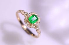 •Condition: Brand new•Center Stone: Natura emerald from Zambia, Emerald Cut approx 0.38ct•Side Stone: Natural white diamond, round cut, approx 0.22ct (VS1 clarity and F color) •Ring Weight: 2.1g•Metal Purity: Optional Each piece is made-to-order with care and special attention to detail. all items are made with conflict-free diamonds and gems.Size: made to orderThe item will be gift wrapped and shipped.---------------------------------------------------------Available in :14k Rose or Yellow Gold Elegant Emerald Ring With Halo Design For Wedding, Exquisite Green Emerald Ring With Halo Setting, Elegant Green Rings With Halo Design, Wedding Emerald Ring With Halo, Wedding Emerald Halo Ring, Heirloom Green Emerald Ring For Wedding, Heirloom Style Green Emerald Wedding Ring, Heirloom Green Emerald Wedding Ring, Green Halo Diamond Ring For Anniversary