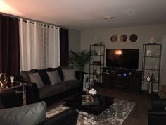 a living room filled with furniture and a flat screen tv