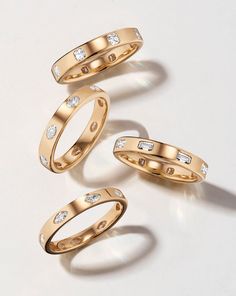 three different types of wedding rings on a white surface