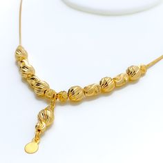 Weighing 10.2 grams, this 21k gold necklace showcases a decorative design with a radiant yellow gold finish, perfect for a dressy occasion. The 17-inch length provides a comfortable fit, while the 1.25-inch drop adds an elegant touch of sophistication. Secured with a lobster lock, this piece combines timeless beauty with intricate craftsmanship, making it an ideal accessory for special events or to elevate everyday style. PRODUCT DETAILS Gold Purity(karat): 21k Gold Weight(grams): 10.2 Item Fini Elegant Gold-plated Gold Necklace, Gold Necklaces With Elegant Pendant Design, Yellow Gold Plated Long Drop Necklace, Gold Bridal Necklace With Pendant And Elegant Design, Elegant 22k Gold Temple Necklace With Gold Beads, Formal Yellow Gold Plated Drop Necklace, Elegant Yellow Gold Temple Necklace With Gold Beads, Elegant Long Yellow Gold Temple Necklace, Elegant Gold-tone Necklace With Gold Beads