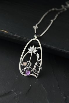 The size H 4 cm x W 3 cm (1 3/4 x 1 inch). Weight - 6g. You can buy it with the chain or without. The most delicate flower of the lotus can make someone very happy. I made this botanical jewelry of sterling silver, amethyst, and peach moonstone. This is a true work of art. It will emphasize your exquisite taste and status, and will also bring a lot of compliments. Lotus flower earrings https://www.etsy.com/listing/676137548/lotus-flower-earrings-sterling-silver?ref=shop_home_active_2&frs=1 O Amethyst Amulet Jewelry For Gifts, Amethyst Amulet Jewelry As Gift, Wire Wrapped Flower Pendant Jewelry Gift, Artistic Silver Wire Wrapped Necklaces, Artistic Silver Wire Wrapped Necklace, Purple Amulet Jewelry As Gift, Purple Amulet Style Jewelry Gift, Purple Amulet Jewelry As A Gift, Art Nouveau Sterling Silver Pendant