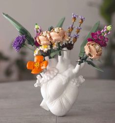 a vase with flowers in it sitting on a table