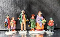 a group of figurines sitting next to each other on top of a table