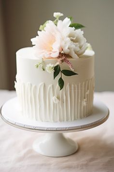 there is a white cake with flowers on it