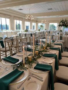 the table is set with candles, plates and silverware for an elegant wedding reception