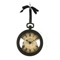 an old clock hanging from a black ribbon