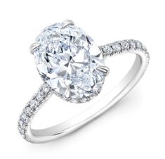 an oval cut diamond engagement ring with pave set shoulders