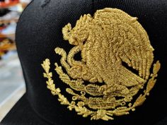 SnapBack Mexican Eagle logo Hat The classic cap, with a high-quality embroidered design, combining the colors of the Mexican flag and the Mexican Shield 80% Acrylic, 20% Wool Bull Logo High Quality Embroidery Mexican Flag to the side with High Quality Embroidered TYPE CAP: Yupoong ORIGINAL EDITION SOLD By: PeligroSports QUALITY: Shield and Flag Top quality embroidery, Resistant material PRACTICAL PRODUCT: SanapBack MANUFACTURED BY PeligroSports: The original edition of this product is made by PeligroSports do not buy imitations of poor quality. Buy PeligroSports version only / La edición original de este producto es fabricado por peligrosports no compre imitaciones de mala calidad. Compre sólo la versión de PeligroSports Embroidered Gold Cap Hat, Gold Embroidered Cap Hat, Gold Embroidered Cap, Embroidery Mexican, Mexican Eagle, Mexican Flag, Mexican Flags, Bull Logo, Gold Hats