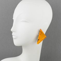 This is part of Chairish’s Costume Jewelry assortment.  Beautiful oversized Lucite clip-on earrings designed by Harriet Bauknight for Kaso. A geometric triangle shape features a dimensional layer with a neon orange mirror-textured pattern and large beveling. The Kaso brand paper sticker was removed, but the gray background and the specific rotating clip fastening are unmistakable brand signatures. Harriet Bauknight is an American Fashion designer who worked in the 1980s and the 1990s under the b Modern Triangle Party Earrings, Modern Triangle Earrings For Party, Modern Yellow Earrings For Party, Orange Mirror, American Fashion Designers, Geometric Triangle, Antique Earrings, Accessories Jewelry Earrings, Triangle Shape