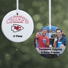 two ornament hanging from a string with the words wisconsin and one man holding a cup