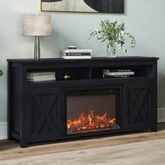 an entertainment center with a fireplace in the middle and a painting on the wall behind it