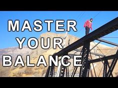 a man standing on top of a metal structure with the words, master your balance