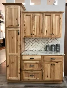 a kitchen with wooden cabinets and tile backsplashes on the wall above it