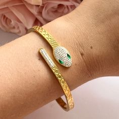 This elegant 14k gold plated snake wrap bracelet is vintage from the 1980s. Snap opening bangle. With silver diamantés and 2 green ones for eyes. Inside circumference: 6.5 inches. Width: 0.5cm. www.vintageamara.co.uk Hypoallergenic: The hypoallergenic property of stainless steel ensures that you can wear your jewelry without worries, even if you have sensitive skin. Water Resistant: Our finishes allow you to expose your everyday jewelry to water while keeping their shine and finishes intact. 14k Hard Metal, Bracelet Bangle, Everyday Jewelry, Gold Plated Jewelry, Wrap Bracelet, Favorite Jewelry, Bangle Bracelets, Jewelry Bracelets, Accessory Gift