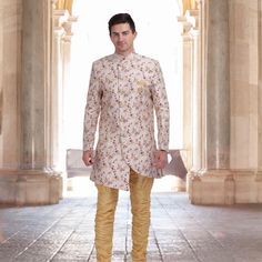 Introducing the Unique Indo Western Sherwani in printed Silk! This magnificent sherwani is made with soft cotton lining and a unique offwhite color silk fabric with delicate print. The matching gold hunter pants complete the look of this regal outfit. Perfect for special occasions, weddings, and festivals, this sherwani is sure to make you stand out from the crowd. Order now and make a grand entrance at your next event! #chirosbyjigyasa #indianclothingusa Bollywood Style Festive Sherwani With Printed Motifs, Festive Bollywood Sherwani With Printed Motifs, Bollywood Sherwani With Printed Motifs For Transitional Season, Traditional Drape Sherwani With Printed Motifs For Festivals, Cream Kurta With Printed Motifs For Wedding, Festive Fitted Sherwani With Printed Motifs, Diwali Bandhgala With Printed Motifs, Wedding Bandhgala With Printed Motifs, Fitted Sherwani With Printed Motifs For Eid