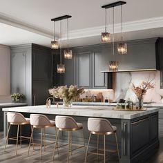 a kitchen with gray cabinets and marble counter tops, gold accents and stools in front of the island