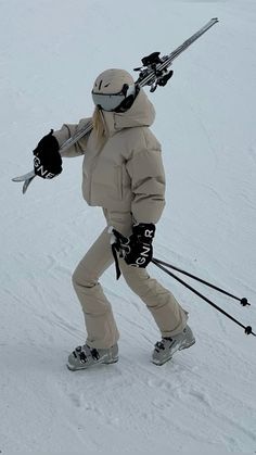 a person on skis in the snow with their arms out and one hand up