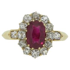 Here we have a fabulous ruby and diamond cluster ring. This antique piece has been crafted from a warm 18ct yellow gold and features an oval faceted rich vivid red ruby of Burmese origin. This outstanding principal stone sits slightly risen in a 12 clawed setting whilst being framed around the outer edge by a circulating array of chunky old mine cut diamonds. A single perfectly matched diamond can be found at either shoulder before the piece is made complete by a neat knife edge band. Condition: Used (Very Good) Weight: 3.2 grams Ring Size: M 1/2 (53) Band Width: 2mm - 1mm Face Dimensions: 13.5mm x 11mm Ruby Weight: Approx. 1.07ct Ruby Details: Origin: Burma, Treatment: None Grading Laboratory: SSEF Total Diamond Weight: Approx. 0.65ct Diamond Details: Approx Colour: H-J, Clarity: VS-SI Ma Pearl Cluster Ring, Gold Cocktail, Pearl Cluster, La Face, French Antique, Ruby Diamond, Diamond Cluster Ring, Red Ruby, Dream Jewelry