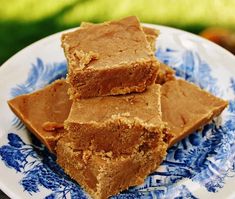 three pieces of peanut butter fudge cake on a blue and white plate with flowers