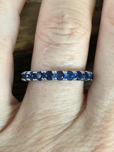 A simple and elegant royal blue sapphire (natural) full eternity ring.    The original ring was from a small estate sale in Chelsea, London, and was stunning.  We decided to recreate the exact ring and make it available again.  It is a classic 2mm stacking full eternity ring.  Perfect for that September birthday also.  Natural Round Cut Royal Blue Sapphires (heated)925 Sterling Silver/RhodiumGift Box Luxury Royal Blue Sapphire Round Ring, Luxury Sapphire Ring For Formal Occasions, Round Cut, Luxury Sapphire Round Eternity Band, Royal Blue Brilliant Cut Fine Jewelry Rings, High-end Classic Royal Blue Rings, Chelsea London, September Birthday, Full Eternity Ring, Blue Band