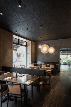 an empty restaurant with wooden tables and chairs