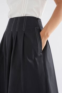 Product Details The Takt Skirt is a contemporary take on a classic cotton poplin midi skirt. The skirt's dramatic waist tucks are highlighted by striking contrast stitching that is placed to create a faux corseting effect. Elevated by bold structural elements and statement stitching - the Takt Skirt offers versatility without being standard. Crafted from Australian-grown cotton Featuring functional side seam pockets. Invisible side seam zipper Contrast top stitch detailing Material 100% Australi Aline Skirt Outfit, Side Seam Pocket, Pilgrim Jewellery, Cotton Poplin Top, Poplin Skirt, Contrast Top, Zipper Skirt, Poplin Top, Aline Skirt