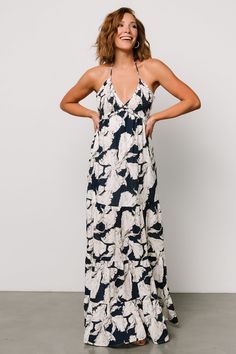 Picture yourself having the time of your life this summer in our Visalia Maxi Dress! With a floral print, smocked bust, and open back, this dress is a great pick for a range of warm-weather activities! White Rayon Maxi Dress For Beach, Vacation Floral Print Maxi Dress For Brunch, Floral Print Maxi Dress For Vacation Brunch, Summer Halter Dress With Adjustable Straps For Beach, Beach Halter Sundress With Adjustable Straps, Summer Tropical Dress With Smocked Back, White Summer Maxi Dress In Rayon, White Summer Rayon Maxi Dress, White Rayon Summer Maxi Dress