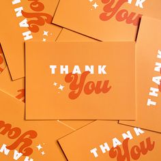 orange thank you cards with white stars and the words thank you written in red on them