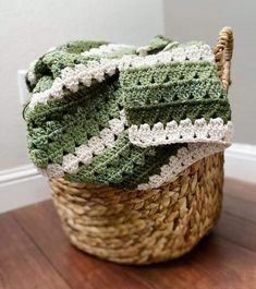 Crochet blanket with striped colours of light, medium and dark green, and white, draped loosely over a woven basket. Crocheting Blanket, Granny Hexagon, Crochet Modern, Granny Stripe Blanket, Green Baby Blanket, Granny Blanket, Hantverk Diy