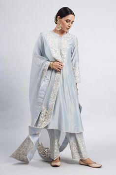 Teal blue kurta with princess-cut, placement floral motif parsi gara embroidery and pearl lace border. Comes with dogri salwar and silk organza dupatta.
Component: 3
Embroidered
Neckline: Band Collar
Sleeve Length: Three Quarter
Fabric: Kurta: Chanderi Silk; Salwar: Bamber Satin; Dupatta: Silk Organza
Color: Blue
Princess-cut
Concealed placket
A-line silhouette - Aza Fashions Salwar Pants, Blue Kurta, Indian Suits, Pearl And Lace, Fancy Dress Design, Organza Dupatta, Embroidered Neckline, Indian Fashion Designers, Silk Organza