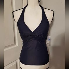 This Stylish Athleta Tankini In A Blue Color Is Perfect For Women Who Love To Swim With Comfort And Style. The Halter Strap Style And Underwire Design Provide Excellent Support, While The Twist Front And Solid Pattern Give It A Trendy Look. The Tankini Comes With Removable Pads For Added Convenience And Is Machine Washable For Easy Maintenance. The Regular Fit Make It An Ideal Choice For Women Who Prefer Comfortable Yet Fitting Swimwear. Fitted Halter Neck Tankini For Sports, Halter Neck Fitted Tankini For Sports, Fitted Halter Neck Sports Tankini, Sporty Blue Sleeveless Tankini, Blue Stretch Tankini For Workout, Sporty Fitted Halter Neck Tankini, Blue Sporty Tankini For Workout, Fitted Halter Neck Tankini For Workout, Blue Fitted Athleisure Tankini