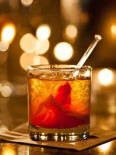 a close up of a drink in a glass on a table