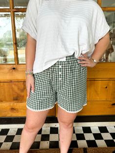 Slip into comfort with The Cherrie Boxer Shorts. Made with adorable gingham print and delicate lace lining, these boxers are not only stylish but also ultra-comfortable. The logo patch adds a touch of charm while the three button details provide a fun detail! Ava in Green is wearing a size Small. Height is 5’3”, Bust is 34”, Waist is 26”, and Hips 32”. Ashley in Red is wearing a size Medium. Height is 5’6”, Bust is 34”, Waist is a 28. Vintage Havana, Top Graphic Tees, Gingham Print, Sweater Set, Boxer Shorts, Mens Outerwear, New Arrival Dress, Deep Green, Mens Graphic Tee