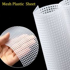 the mesh plastic sheet is being held by someone's hand