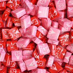 red and pink candy cubes are piled up on top of each other in rows