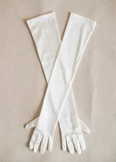 two white gloves on top of each other, one with long sleeves and the other with short arms