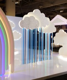 an art installation with clouds and rainbows on display