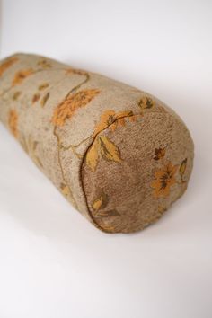 a rolled up pillow sitting on top of a white table