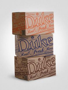 three boxes stacked on top of each other with the words duke written on them in orange and blue