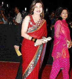 two women in sari walking down the red carpet