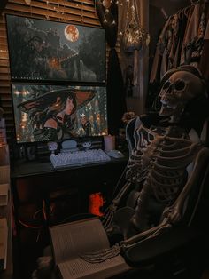 a skeleton sitting in front of a computer monitor