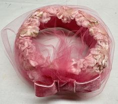 "This vintage ladies fascinator/pill box hat is quite lovely. Decorated in pink silk flowers with a hint of green at the centers. It has pink netting and a large velvet pink bow. It has no rips stains or tears It measures 7 1/2\" x 7\"  It comes in a cardboard hat box for storage" Vintage Fascinator For Kentucky Derby Gift, Pink Hat Fascinator As Gift, Pink Hat-shaped Fascinator As Gift, Pink Cloche Mini Hat For Evening, Vintage Pink Hat For Royal Ascot, Vintage Pink Evening Hat, Vintage Pink Hat For Evening, Vintage Pink Mini Hat For Party, Pink Vintage Fascinator For Kentucky Derby