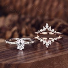 three different types of wedding rings on top of a wooden table