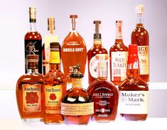 many different types of liquor bottles lined up