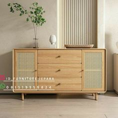 the sideboard is made out of wood and has metal mesh panels on it, along with a potted plant