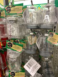 many plastic jars are stacked on top of each other and labeled with labels for sale